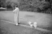 VP Singh walking in the garden at his residence, with a lone follower