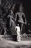 A woman stands in front of sculptures in the Elephanta Caves
