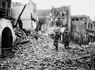 British soldiers walk through Amritsar surveying the damage caused by rioting