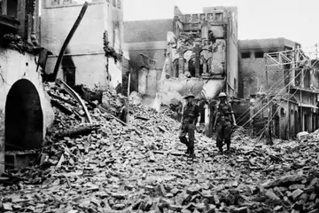 British soldiers walk through Amritsar surveying the damage caused by rioting