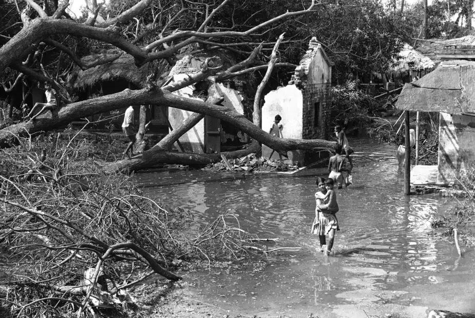 Children walk through the flooded ruins of Bhadrak, Orissa after the 1971 Cyclone