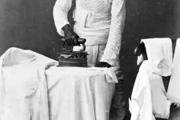 Colonial era Dhobi irons various Clothes using a Charcoal Iron