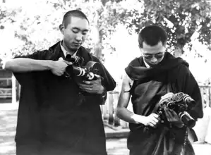 The Panchen Lama and Dalai Lama set up their film cameras before entering the Elephanta Caves in Bombay, India