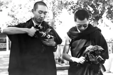 The Panchen Lama and Dalai Lama set up their film cameras before entering the Elephanta Caves in Bombay, India