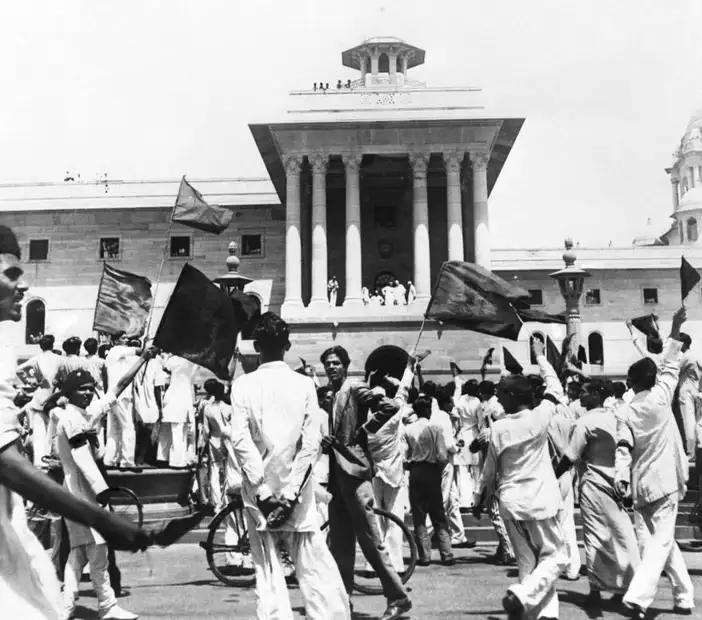 Muslim League protestors wave black flags at members of the first Cabinet of the Interim Government of India