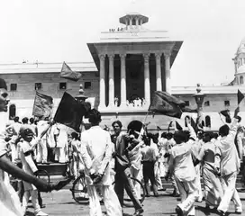 Muslim League protestors wave black flags at members of the first Cabinet of the Interim Government of India